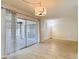 Bright living room featuring wood-look flooring and sliding glass doors to a patio at 1041 Bowsprit Ln # 1041, Holiday, FL 34691