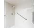 Clean white tiled shower with a handheld shower head at 1041 Bowsprit Ln # 1041, Holiday, FL 34691