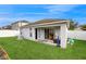 This backyard boasts lush green grass with a partially covered outdoor patio area at 10739 Shady Preserve Dr, Riverview, FL 33579