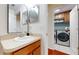 Well-lit bathroom featuring wood cabinets, laminate countertops, and modern fixtures at 10739 Shady Preserve Dr, Riverview, FL 33579