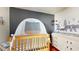 Cozy Bedroom featuring a wooden crib and a dresser with changing table at 10739 Shady Preserve Dr, Riverview, FL 33579