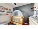 Bedroom featuring a wooden crib, a dresser with changing table, and decorative wall art at 10739 Shady Preserve Dr, Riverview, FL 33579