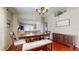 Cozy dining area with wooden table, bench seating, and modern chandelier at 10739 Shady Preserve Dr, Riverview, FL 33579