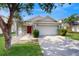 Charming single-story home with lush landscaping and a welcoming red front door at 10739 Shady Preserve Dr, Riverview, FL 33579