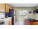 Bright kitchen with stainless steel appliances and sliding glass door to the backyard and play area at 10739 Shady Preserve Dr, Riverview, FL 33579