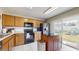 Functional kitchen with stainless steel appliances, wood cabinets, and access to the backyard at 10739 Shady Preserve Dr, Riverview, FL 33579