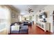 Bright living room featuring hardwood floors, a plush couch, and lots of natural light at 10739 Shady Preserve Dr, Riverview, FL 33579