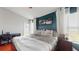 Spacious main bedroom with hardwood floors, neutral paint, and ample natural light from the two large windows at 10739 Shady Preserve Dr, Riverview, FL 33579