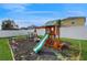 A beautiful playground set with a green slide, climbing wall, and swings at 10739 Shady Preserve Dr, Riverview, FL 33579