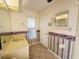 Well-lit bathroom with a vanity, mirror, patterned wallpaper, and tile flooring at 10806 Brookhaven Dr, New Port Richey, FL 34654