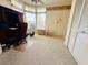 Bright bedroom featuring neutral carpet, closet, and plenty of natural light from large windows at 10806 Brookhaven Dr, New Port Richey, FL 34654