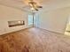 Spacious carpeted bedroom with ceiling fan, natural light, and ample closet space ready for personalization at 10806 Brookhaven Dr, New Port Richey, FL 34654