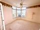 Charming bedroom featuring a bay window and ceiling fan offering natural light and comfortable living at 10806 Brookhaven Dr, New Port Richey, FL 34654