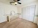 Bright bedroom with neutral carpet, a ceiling fan, closet and a mirrored vanity at 10806 Brookhaven Dr, New Port Richey, FL 34654
