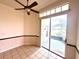 Cozy dining area with tile floors, ceiling fan, and sliding glass doors leading to the outdoors at 10806 Brookhaven Dr, New Port Richey, FL 34654