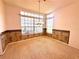 Elegant dining area boasting carpeted floors, large windows, and a decorative chandelier at 10806 Brookhaven Dr, New Port Richey, FL 34654