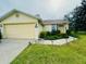 Charming one-story home with a well-maintained lawn, two-car garage, and inviting landscaping at 10806 Brookhaven Dr, New Port Richey, FL 34654