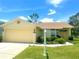Charming single-story home with a manicured lawn, two-car garage, and inviting front entrance at 10806 Brookhaven Dr, New Port Richey, FL 34654
