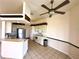 Bright kitchen with white appliances, tile flooring, and a breakfast bar for casual dining at 10806 Brookhaven Dr, New Port Richey, FL 34654