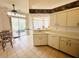 Well-lit kitchen featuring stainless steel appliances, tiled floors, and an adjacent dining area with sliding glass doors at 10806 Brookhaven Dr, New Port Richey, FL 34654