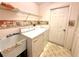 Functional laundry room with washer, dryer, utility sink, and shelving for storage at 10806 Brookhaven Dr, New Port Richey, FL 34654