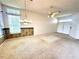 Expansive living space featuring vaulted ceilings, large windows, carpet, and chandelier lighting at 10806 Brookhaven Dr, New Port Richey, FL 34654