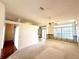 Open living space with carpet, ceiling fan, and large windows allowing natural light to flow through at 10806 Brookhaven Dr, New Port Richey, FL 34654