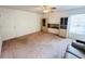 Spacious living room featuring neutral carpet, ceiling fan, large window and built-in shelving at 10806 Brookhaven Dr, New Port Richey, FL 34654