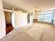 Bright living room featuring carpet, sliding door, large windows, and an open floor plan at 10806 Brookhaven Dr, New Port Richey, FL 34654