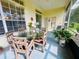 Cozy screened patio perfect for outdoor dining and relaxation, with a glass table and ample seating at 10806 Brookhaven Dr, New Port Richey, FL 34654