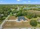 Property with a pool and long driveway highlighted from overhead with natural landscapes at 11137 Woodland Waters Blvd, Weeki Wachee, FL 34613