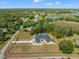 Expansive property featuring a stunning home, lush greenery, and a refreshing swimming pool area at 11137 Woodland Waters Blvd, Weeki Wachee, FL 34613