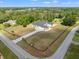 Wide aerial view highlights the property, long driveway and the surrounding greenery at 11137 Woodland Waters Blvd, Weeki Wachee, FL 34613