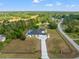 Overhead shot of a property with a pool, long driveway, and lush green surroundings at 11137 Woodland Waters Blvd, Weeki Wachee, FL 34613