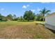Expansive backyard featuring well-maintained green grass and a large shade tree at 11137 Woodland Waters Blvd, Weeki Wachee, FL 34613