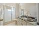 Bathroom featuring granite countertops, a sliding glass shower door, and neutral colors at 11137 Woodland Waters Blvd, Weeki Wachee, FL 34613