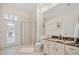 Bathroom features marble countertop, glass shower, and outdoor access to lanai area at 11137 Woodland Waters Blvd, Weeki Wachee, FL 34613