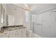 Bathroom features granite countertop, a large mirror, and a walk-in shower at 11137 Woodland Waters Blvd, Weeki Wachee, FL 34613
