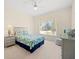 Bright bedroom with a large window, ceiling fan, and carpeted floors at 11137 Woodland Waters Blvd, Weeki Wachee, FL 34613