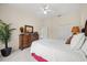 Bedroom features two dressers, closet, queen bed, ceiling fan, and a view of the backyard at 11137 Woodland Waters Blvd, Weeki Wachee, FL 34613