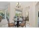 Cozy dining area with large windows, a glass-top table, and views to the pool and patio at 11137 Woodland Waters Blvd, Weeki Wachee, FL 34613