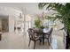 Open-concept dining room with tile flooring, chandelier, and access to adjacent rooms at 11137 Woodland Waters Blvd, Weeki Wachee, FL 34613