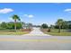 Inviting driveway entrance with brick columns and lush landscaping leading to a beautiful home at 11137 Woodland Waters Blvd, Weeki Wachee, FL 34613