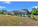 Wide shot of a lovely home's screened-in pool and patio area with pristine landscaping at 11137 Woodland Waters Blvd, Weeki Wachee, FL 34613