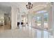 Inviting foyer features tile floors, arched doorways, decorative columns, and plenty of natural light at 11137 Woodland Waters Blvd, Weeki Wachee, FL 34613