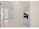 Bright hallway view showcasing access to a bedroom and bathroom with outdoor access at 11137 Woodland Waters Blvd, Weeki Wachee, FL 34613
