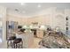 Bright kitchen features stainless steel appliances, granite countertops, and a center island with seating at 11137 Woodland Waters Blvd, Weeki Wachee, FL 34613