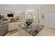 View of kitchen leading to a dining area with a door and large windows overlooking the pool and patio at 11137 Woodland Waters Blvd, Weeki Wachee, FL 34613