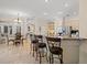 Open kitchen and dining area features granite countertops and seating at the island at 11137 Woodland Waters Blvd, Weeki Wachee, FL 34613
