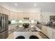 Kitchen boasts ample storage, stainless appliances, and a large island with a granite countertop at 11137 Woodland Waters Blvd, Weeki Wachee, FL 34613